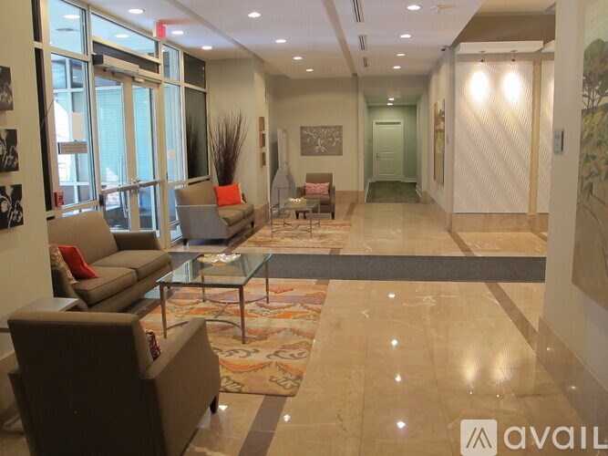 A spacious lobby with a glass table and chairs.