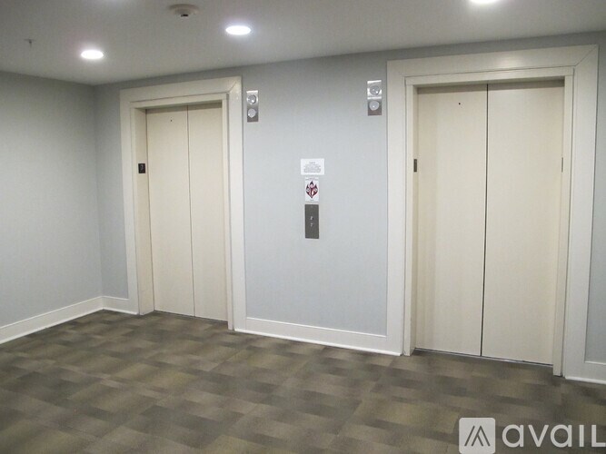 Two white doors with a red and white sign in between.