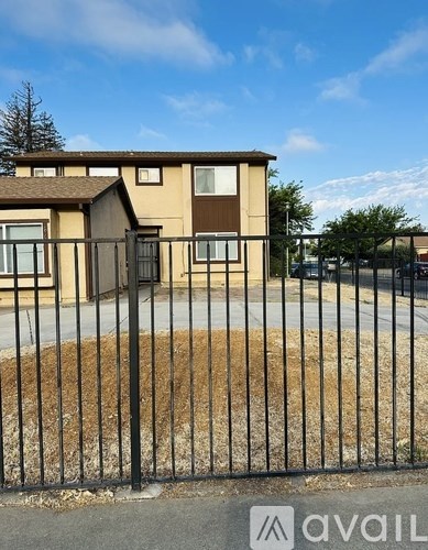 A house with a black fence in front of it.