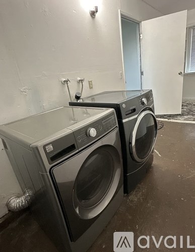 Two front load washing machines in a room.