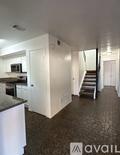 A kitchen with a counter top and a stove top oven.