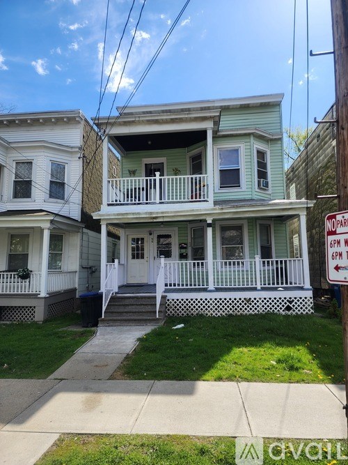 A house with a sign that says "NO PARKING 6PM TO 6AM".