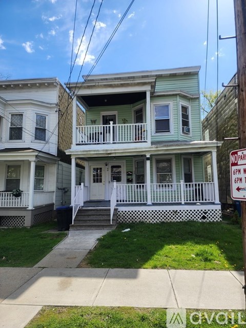 A house with a sign that says "NO PARKING 6PM TO 6AM".