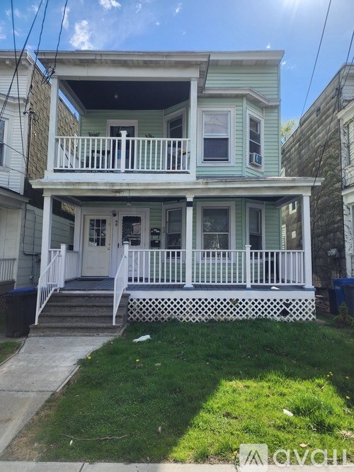 A two-story house with a white porch.