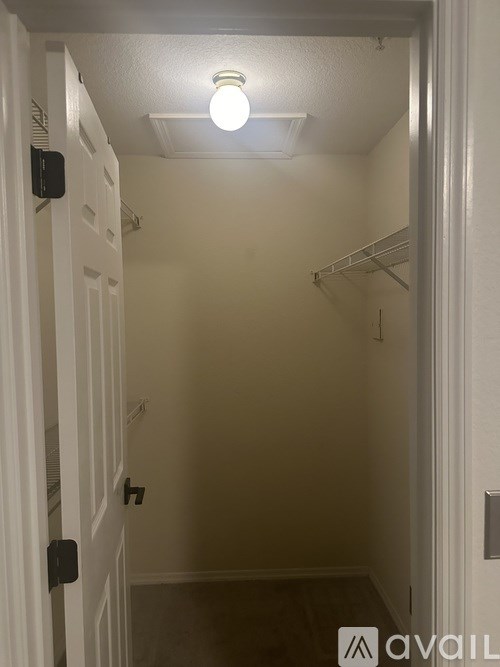 A white door with a black handle and a light on.
