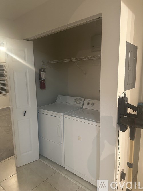 A small laundry room with a washer and dryer.