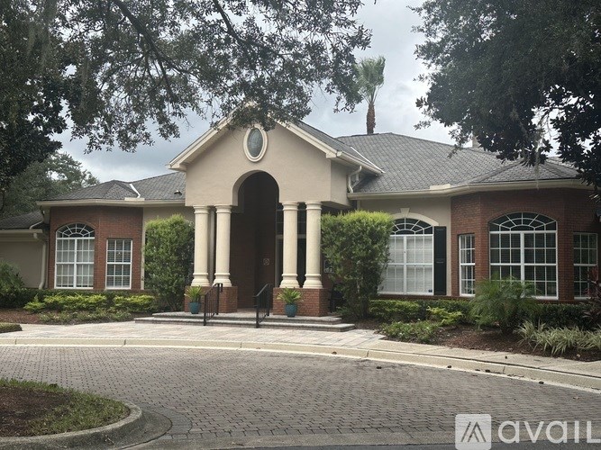 A house with a brick facade and a large arched entrance.