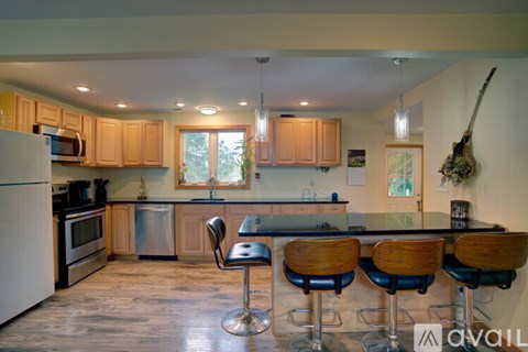 A kitchen with wooden cabinets and a white refrigerator.