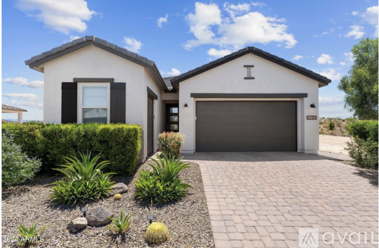 A modern house with a garage and a well-maintained garden.