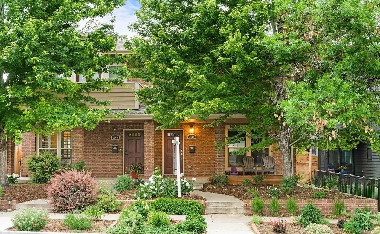 A house with a brown door and a small porch.