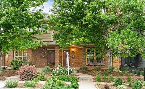 A house with a brown door and a small porch.
