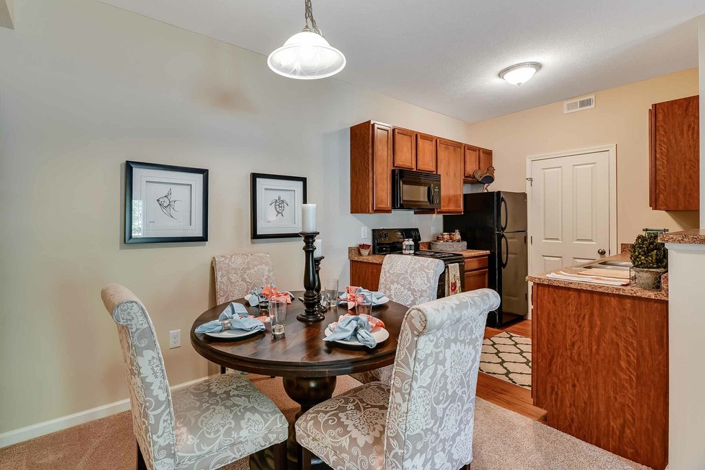 A dining room with a table set for two.