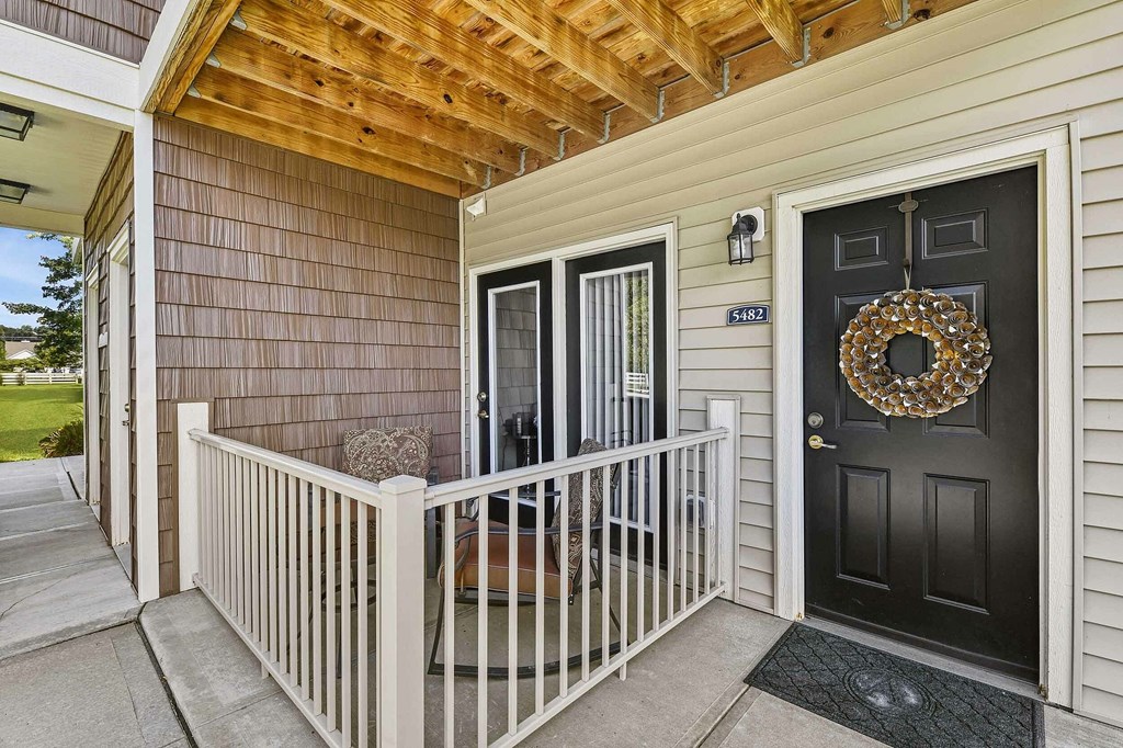 A black door with a wreath on it.