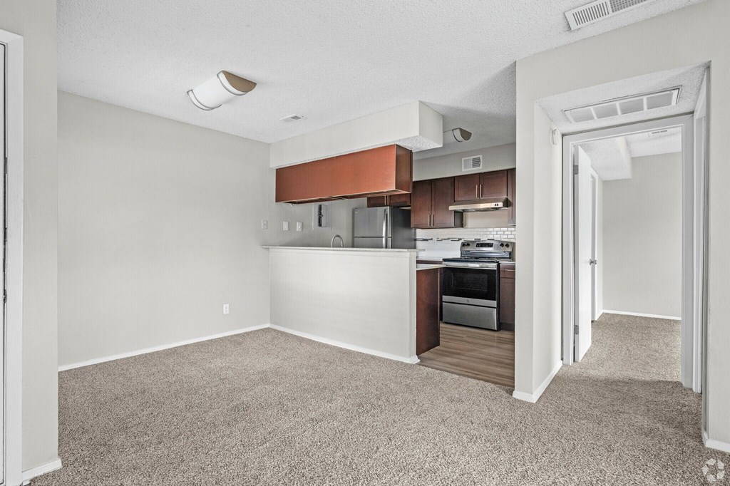 A kitchen area with a refrigerator, oven, and microwave.