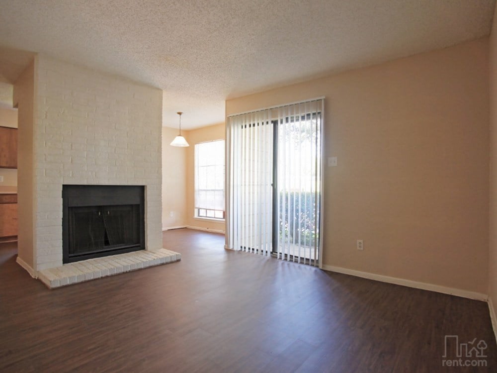 A living room with a fireplace and sliding glass doors.