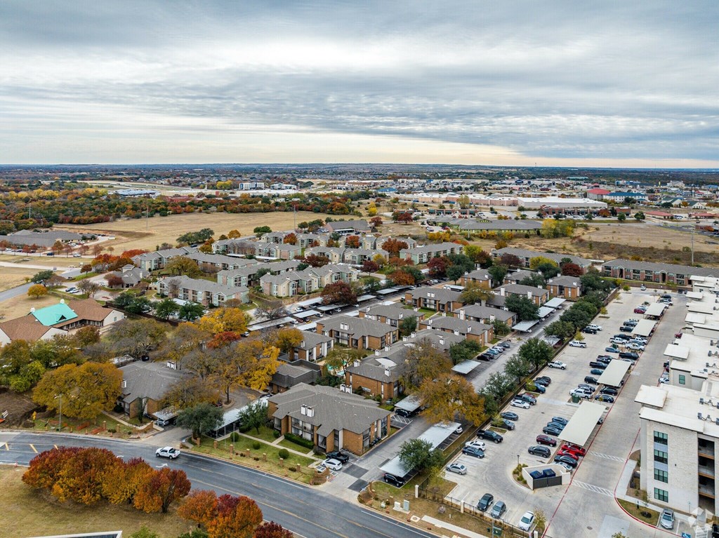 A view of a residential area with houses and cars.
