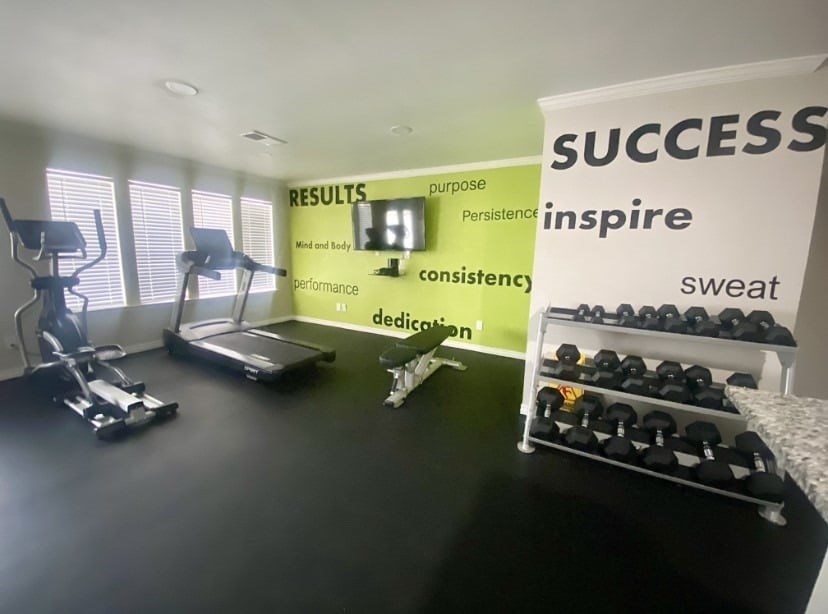 A gym room with a sign that says "SUCCESS" on the wall.