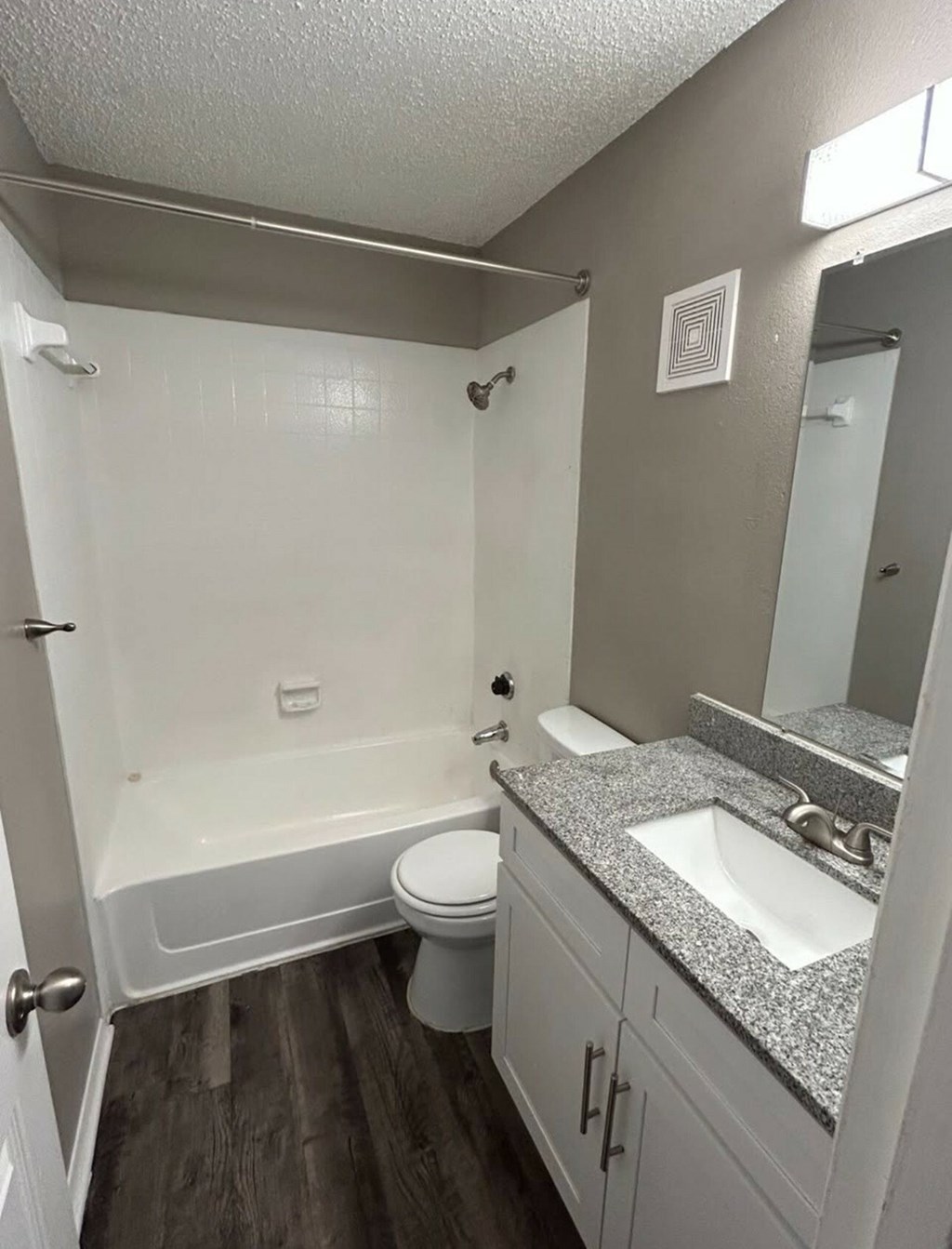 A small bathroom with a toilet, sink, and bathtub.