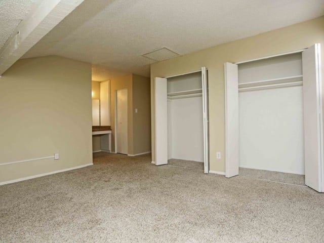 A room with a carpeted floor and white walls.