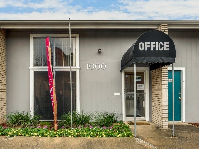 A building with a black awning that says "OFFICE" on it.