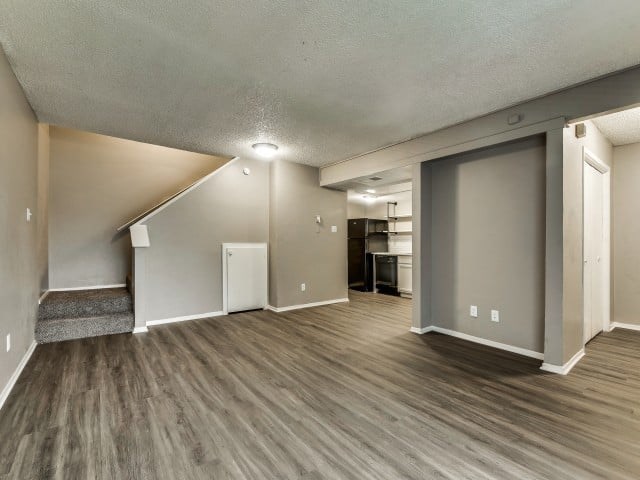 A room with a staircase and a white door.