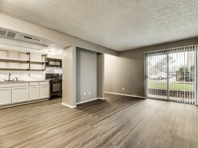 A modern kitchen with wooden floors and a large open space.