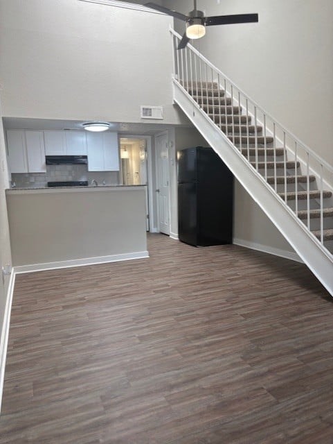 A kitchen with a staircase leading to the upper floor.