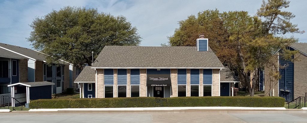 A building with a black sign on the front.