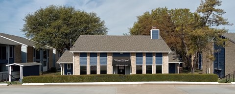 A building with a black sign on the front.