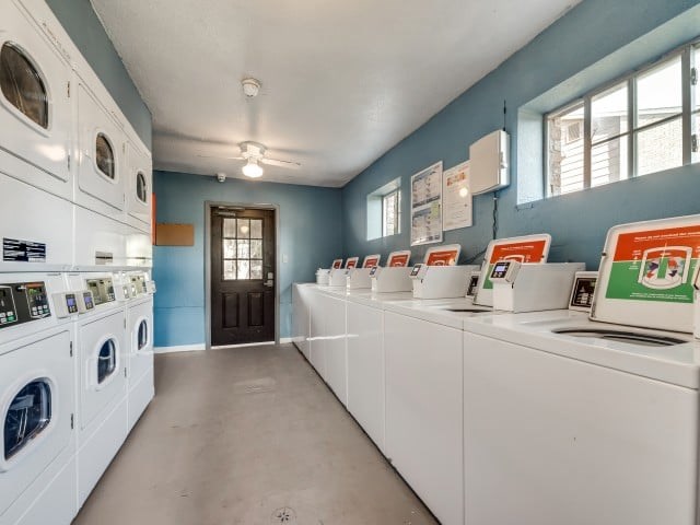 A laundromat with rows of washers and dryers.