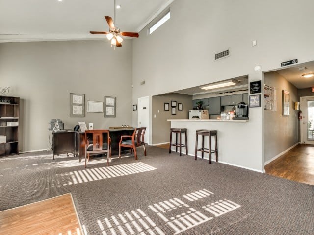 A room with a bar and a dining table.