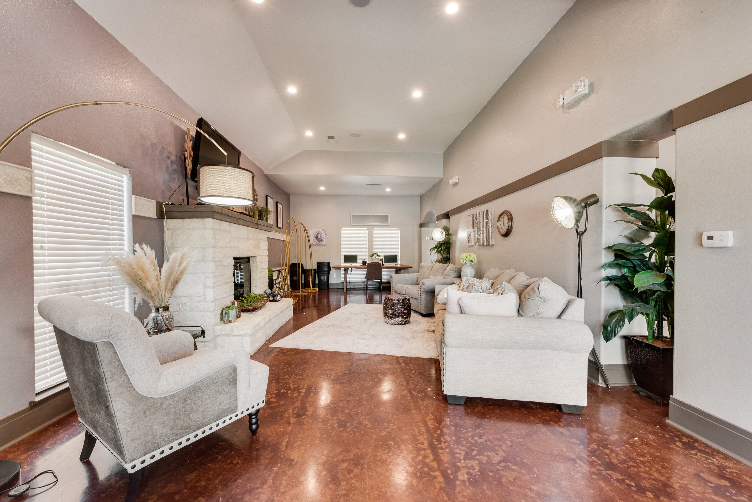 A living room with a grey sofa and a white armchair.