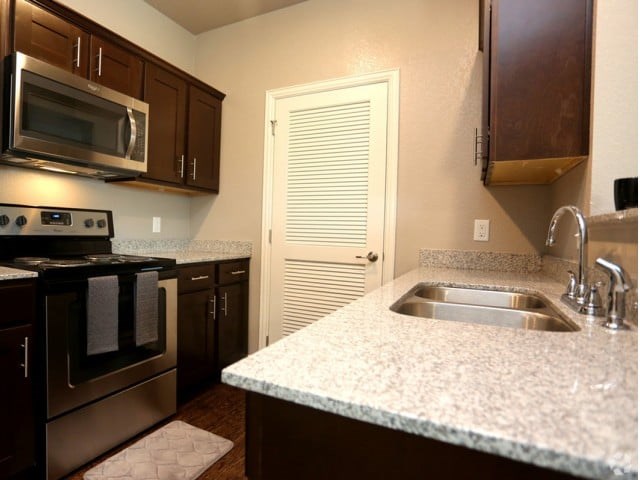 A kitchen with a stove top oven and microwave.
