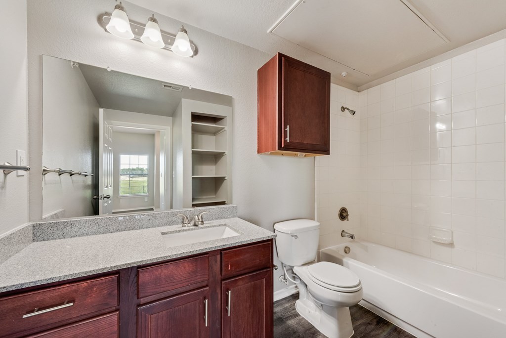 A white bathroom with a toilet, sink, and bathtub.