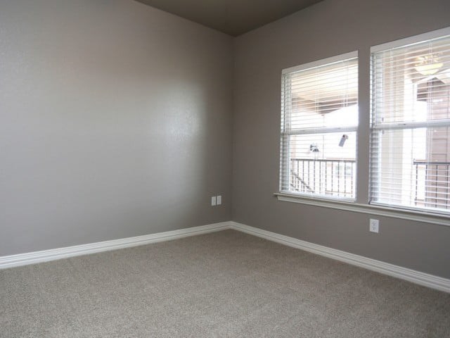 A room with a window and a view of a balcony.