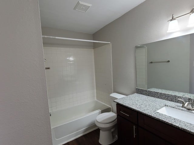 A white toilet sits next to a sink in a bathroom.
