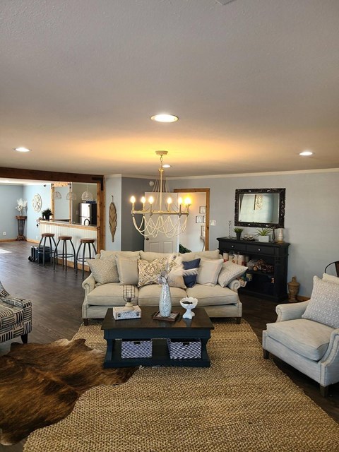 A living room with a white couch and a coffee table.