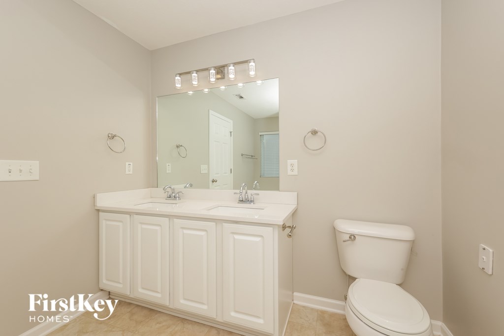 A white bathroom with a toilet and sink.