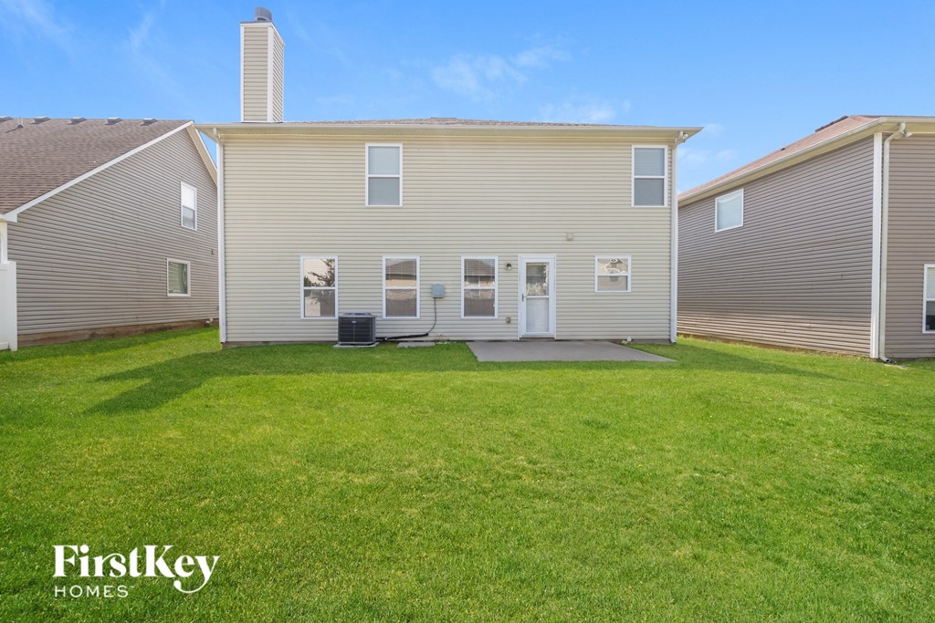 A house with a lawn in front of it.