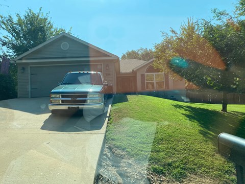 A truck is parked in front of a house.