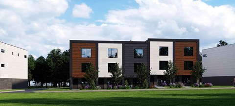 A modern building with a combination of wood and grey exterior.