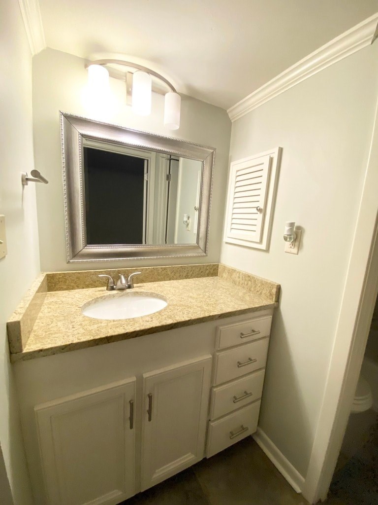 A bathroom with a sink and a mirror.
