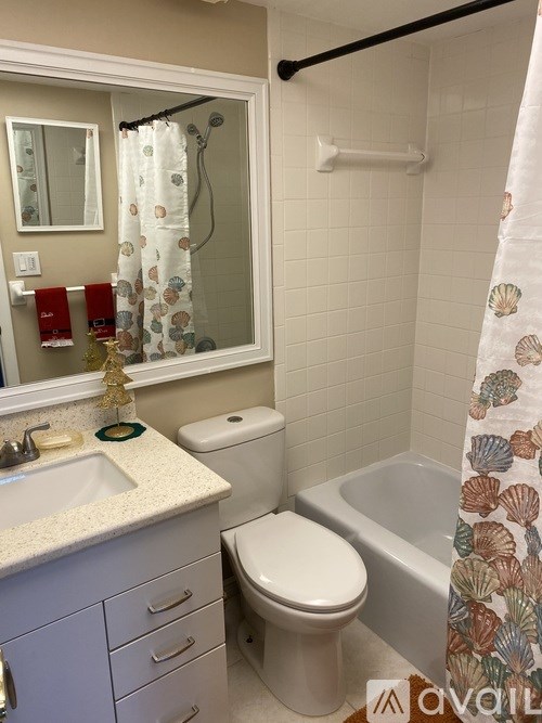 A bathroom with a toilet, sink, and shower.