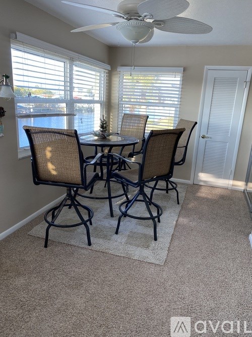 A dining room with a table and chairs.