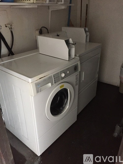 A white washing machine and dryer are stacked on top of each other.