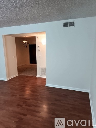 A living room with a grey couch and a television.