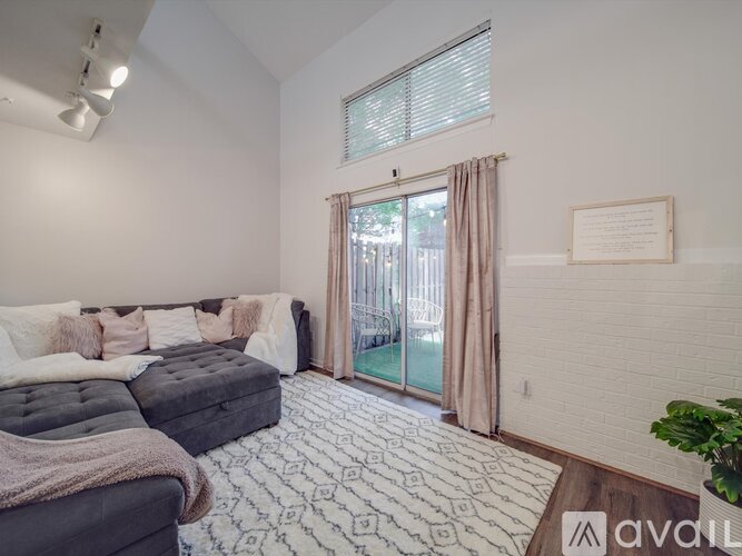 A bedroom with a large bed and a sliding glass door leading to a balcony.
