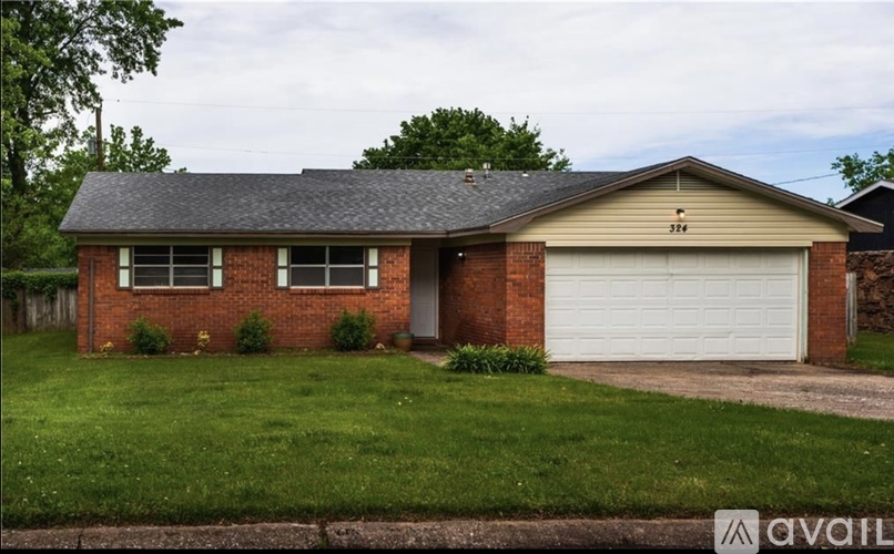 A house with a garage and a driveway is available for sale.