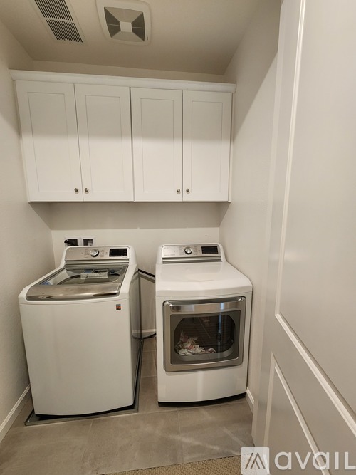 A white dishwasher and oven in a kitchen.