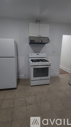 A kitchen with a stove and a refrigerator.